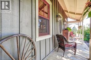Hamilton apartment for rent - A wooden chair sits on a porch next to a window.