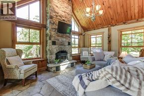 Hamilton apartment for rent - A cozy bedroom with a stone fireplace and a large bed.