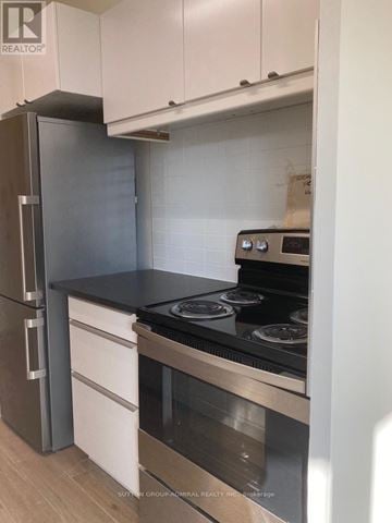 Toronto (Westminster-Branson) condo for rent - A kitchen with a stove and a refrigerator.