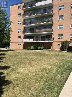 Toronto (Westminster-Branson) condo for rent - A grassy area in front of a multi-story apartment building.