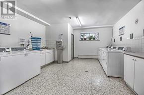 Toronto (Westminster-Branson) condo for rent - A clean, white-walled laundry room with a tiled floor and a window.