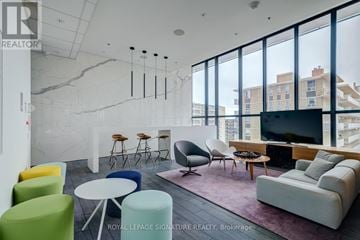 Toronto (Mount Pleasant West) condo for rent - A living room with a white couch and a TV.