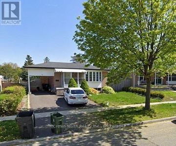 Toronto (Woburn) apartment for rent - A white car is parked in front of a house with a tree to the right.