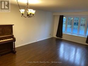 Toronto (Woburn) apartment for rent - A room with a piano and a chandelier.