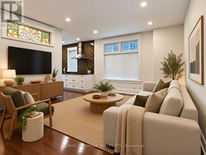 Toronto (Greenwood-Coxwell) apartment for rent - A living room with a couch, a chair, a coffee table, and a television.