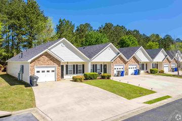 Newnan apartment for rent - A row of houses with a driveway in front.
