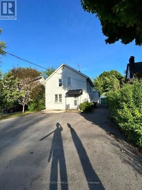 Brampton (Downtown Brampton) apartment for rent - A white house with a shadow of a person in front of it.