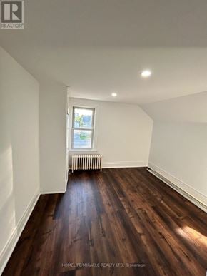 Brampton (Downtown Brampton) apartment for rent - A room with wooden floors and a window with a view of a city.
