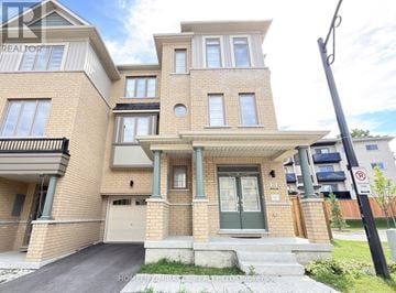 Whitby (Port Whitby) townhouse for rent - A modern two-story house with a garage and a driveway.