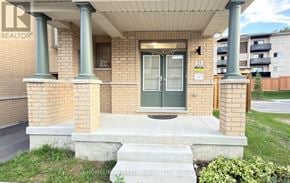 Whitby (Port Whitby) townhouse for rent - A house with a green door and a sign that says "21" on it.