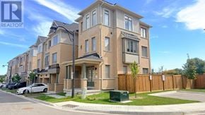 Whitby (Port Whitby) townhouse for rent - A row of townhouses with a realtor logo in the corner.