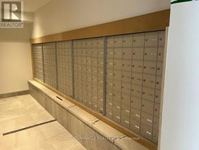 Newmarket (Central Newmarket) condo for rent - A wall of mailboxes in a room with a logo that says REALTOR.