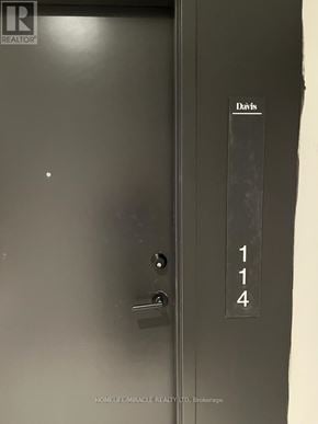 Newmarket (Central Newmarket) condo for rent - A door with a silver handle and a sign on the door reading 114.
