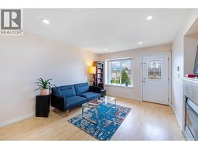 Burnaby apartment for rent - A living room with a blue sofa and a rug.