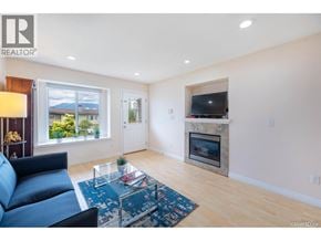 Burnaby apartment for rent - A living room with a blue couch and a fireplace.