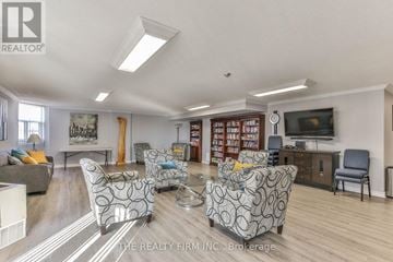 London East (East K) condo for rent - A living room with a grey sofa and a television.