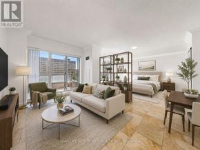 Toronto (Bay Street Corridor) condo for rent - A well-lit, modern living room with a large window, a white sofa, and a coffee table.