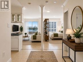 Toronto (Bay Street Corridor) condo for rent - A well-lit, spacious living room with a kitchen area and a view of the city.