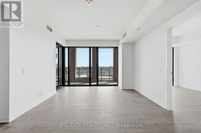 Toronto (Thorncliffe Park) condo for rent - A spacious room with a view of the city through large windows.
