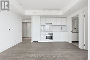 Toronto (Thorncliffe Park) condo for rent - A white kitchen with a refrigerator, oven, and cabinets.