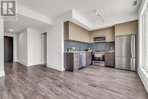Toronto (Edenbridge-Humber Valley) condo for rent - A modern kitchen with wooden floors and stainless steel appliances.