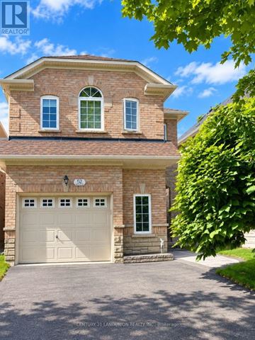Markham (Berczy) apartment for rent - A two-story brick house with a garage and a driveway.