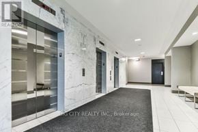 Toronto (Islington-City Centre West) condo for rent - A hallway with marble walls and a carpeted floor.