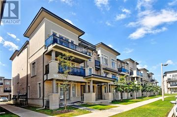 Vaughan (Maple) townhouse for rent - A row of modern townhouses with balconies and a clear blue sky above.