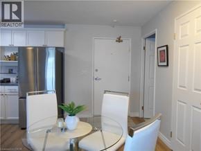 Port Dover condo for rent - A dining room with a glass table and white chairs.