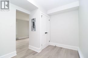 Ottawa triplex for rent - A white door with a black handle and a small window above it.