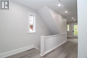 Ottawa triplex for rent - A white room with a window and a skylight.