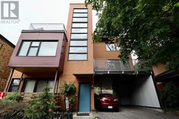 Ottawa triplex for rent - A modern two story house with a garage.