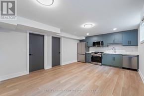 St. Catharines (Carlton/Bunting) apartment for rent - A kitchen with wooden floors and stainless steel appliances.