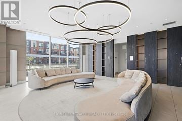 Brampton (Northwest Brampton) condo for rent - A modern living room with a large couch and a coffee table.