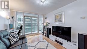 Toronto (Waterfront Communities) condo for rent - A living room with a black leather couch and a flat screen TV.
