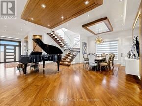Toronto (Newtonbrook East) apartment for rent - A grand piano is in the middle of a spacious room with wood flooring.