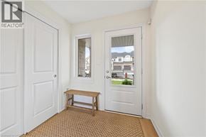 Hamilton townhouse for rent - A room with a white door, a window, and a bench.