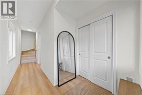 Hamilton townhouse for rent - A hallway with a mirror on the wall and a door on the right.