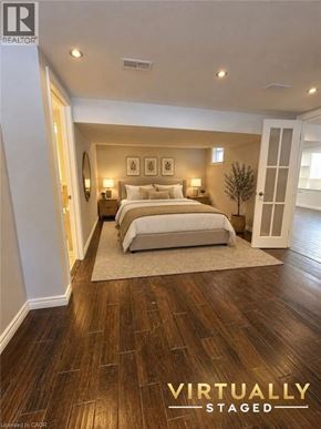 St. Catharines apartment for rent - A bedroom with a large bed and a rug on the floor.