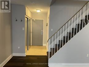 Toronto (Morningside) townhouse for rent - A hallway with a staircase and a door leading to another room.