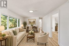 St. Catharines (Haig) apartment for rent - A well-lit living room with a couch, chairs, and a dining table.