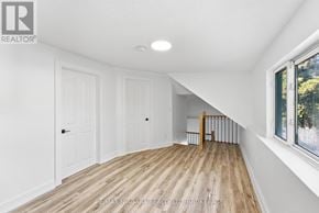 St. Catharines (Haig) apartment for rent - A room with white walls and wooden flooring with a window on the right side.