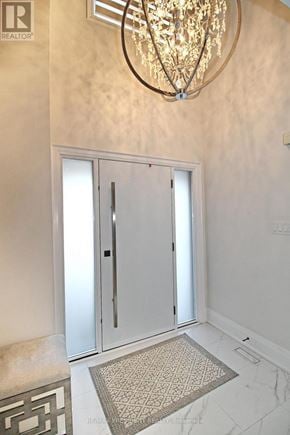 Brampton (Sandringham-Wellington) apartment for rent - A chandelier hangs over a pair of double doors in a hallway.