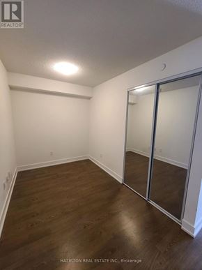 Toronto (Islington-City Centre West) condo for rent - A room with wood flooring and a glass door.