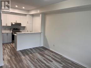 Mississauga (Churchill Meadows) townhouse for rent - A kitchen with white cabinets and a wooden floor.