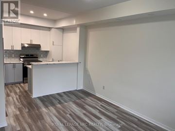 Mississauga (Churchill Meadows) townhouse for rent - A kitchen with white cabinets and a wooden floor.