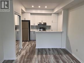 Mississauga (Churchill Meadows) townhouse for rent - A kitchen with white cabinets and a wooden floor.