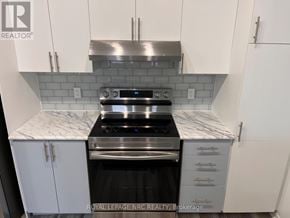 Mississauga (Churchill Meadows) townhouse for rent - A kitchen with white cabinets and a marble countertop.