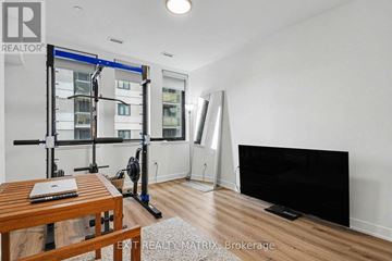 Ottawa apartment for rent - A modern living room with a wooden table and a television.
