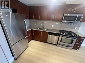 Richmond apartment for rent - A kitchen with a stainless steel refrigerator and a stainless steel oven.